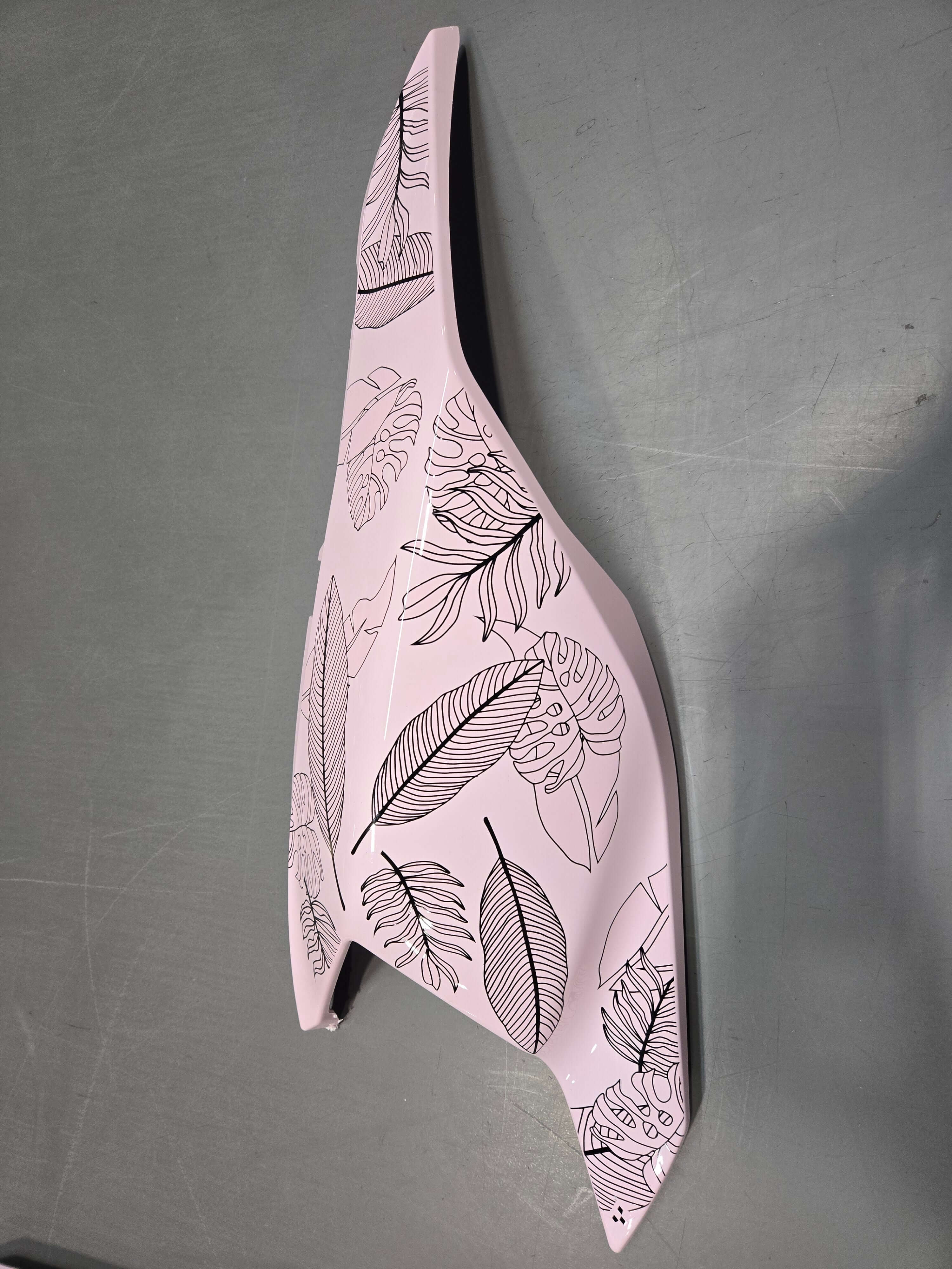 Decorative object with leaf patterns on a gray background