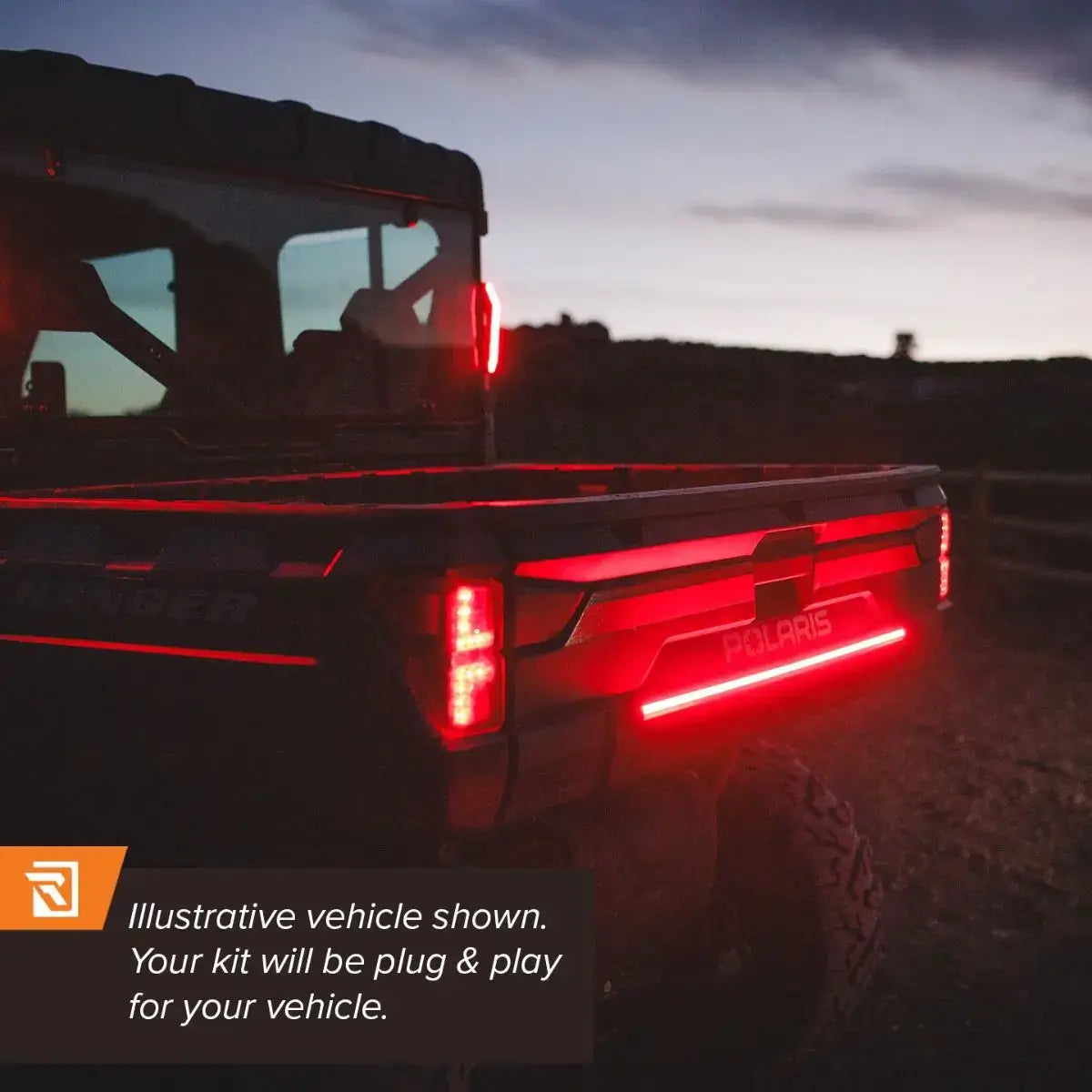 Polaris vehicle with illuminated red tail lights at dusk