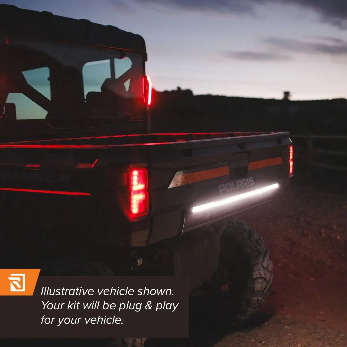 Polaris vehicle with illuminated rear lights at dusk