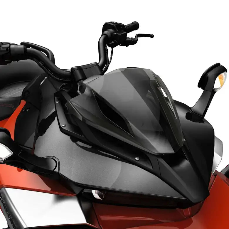 Close-up of a motorcycle with a black windshield on a white background