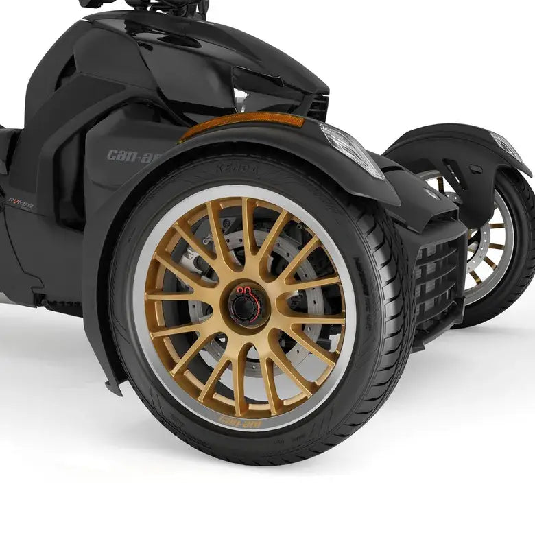 Black three-wheeled vehicle with gold rims on a white background