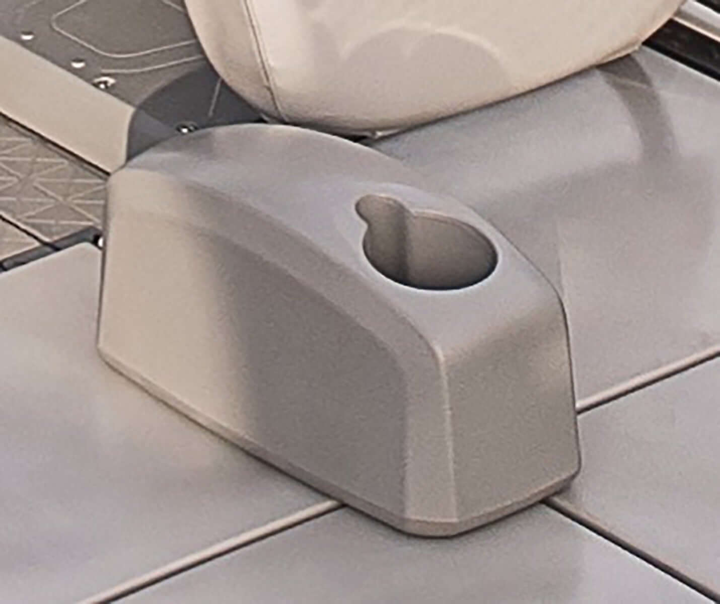 Sea-Doo pontoon armrest cup holder attachment, gray molded plastic, close-up view