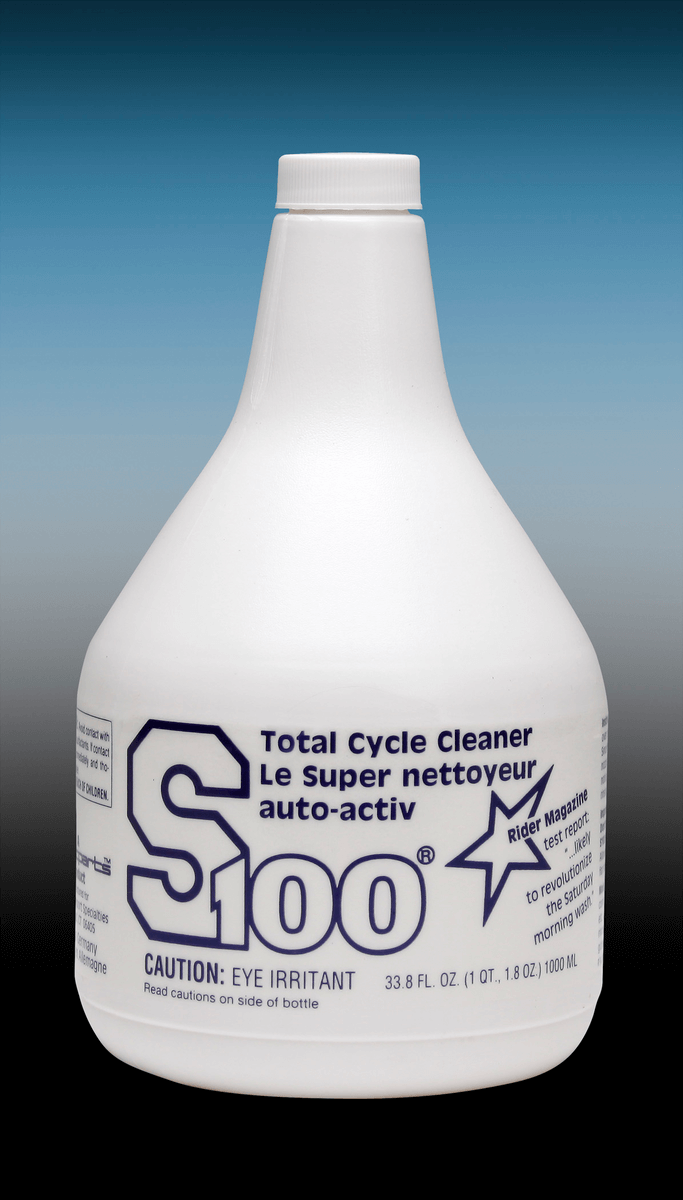 White bottle of S100 Total Cycle Cleaner with blue text on a gradient background