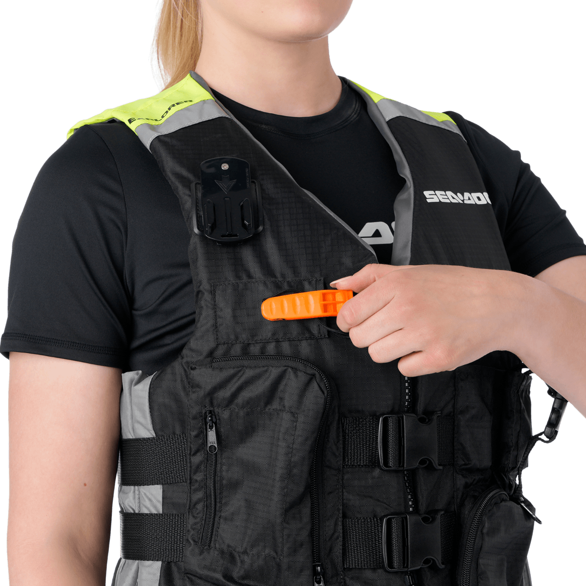 A woman in a life jacket holding an orange emergency whistle