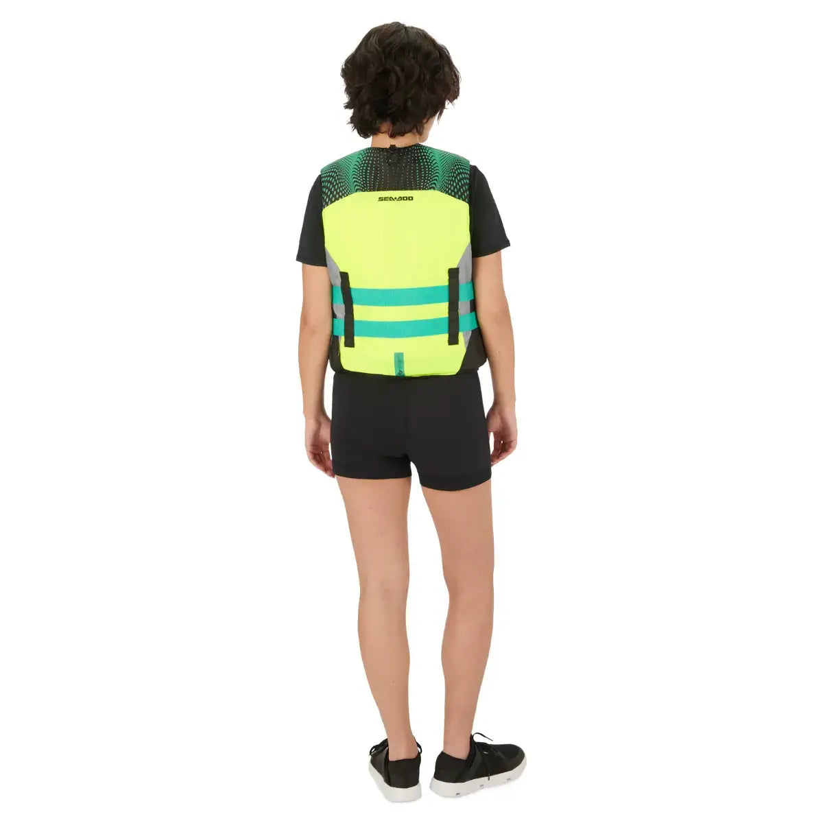 Back view of a person wearing a bright yellow Sea-Doo Motion PFD life jacket designed for water sports and safety.