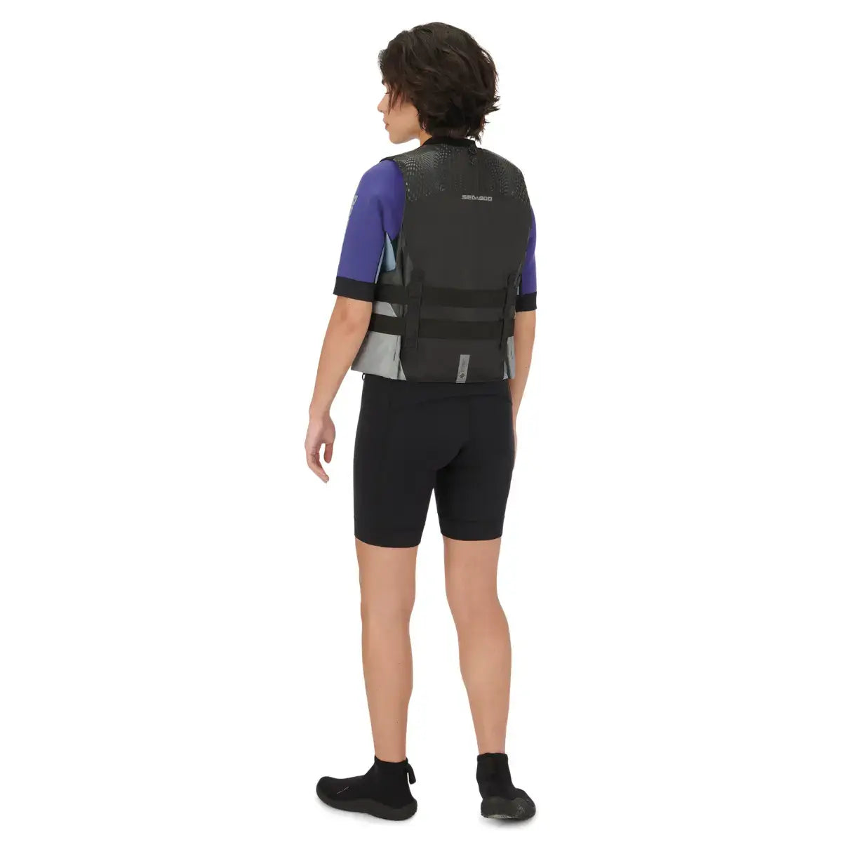 Rear view of a person wearing a Sea-Doo unisex Motion PFD life jacket, showcasing its sleek design and adjustable straps.