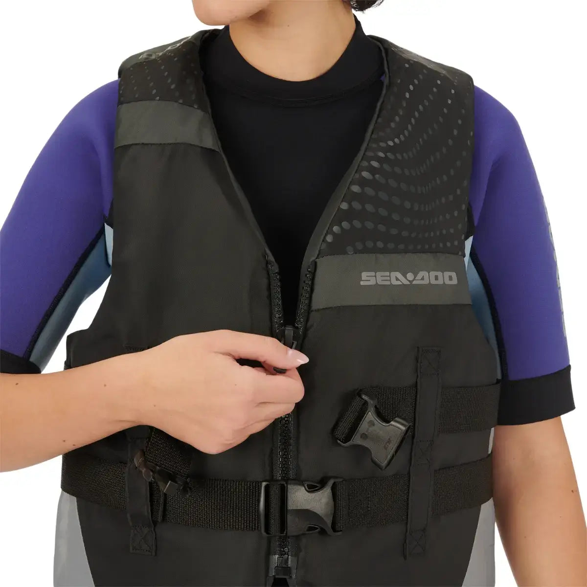 Close-up of a person wearing a Sea-Doo Motion PFD life jacket with adjustable straps and a sleek design.