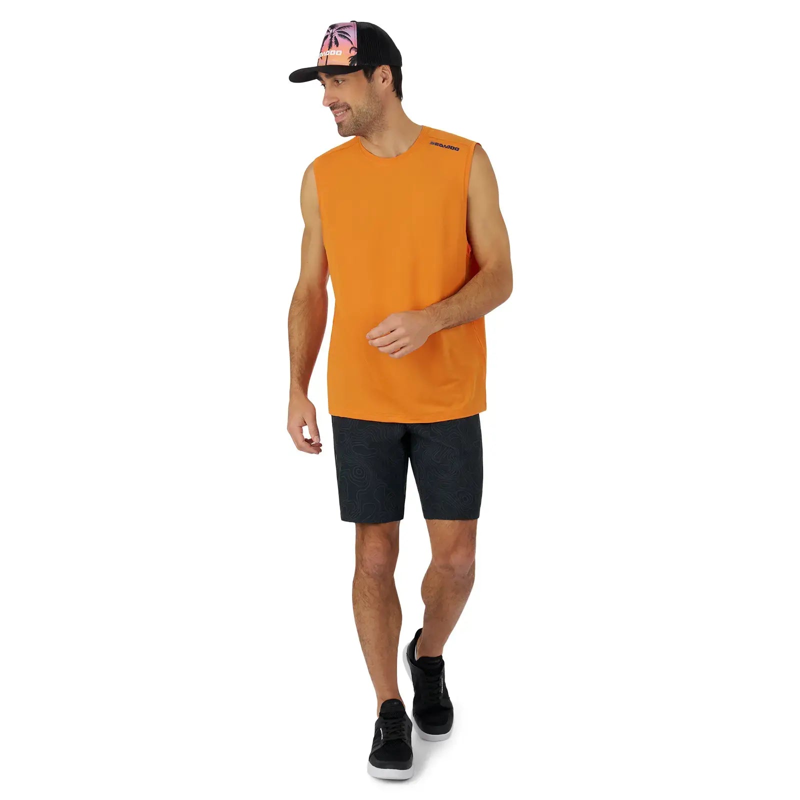 Man wearing an orange Men’s Lightweight Crew Tank Top, paired with shorts and a cap, ideal for Sea-Doo adventures.