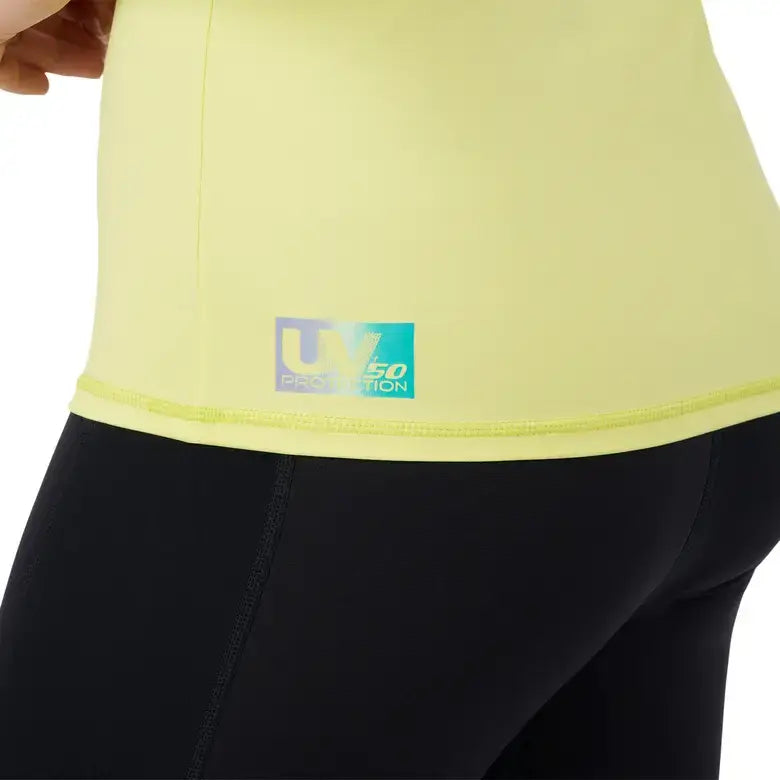 Close-up of a yellow top with UV protection logo and black pants.