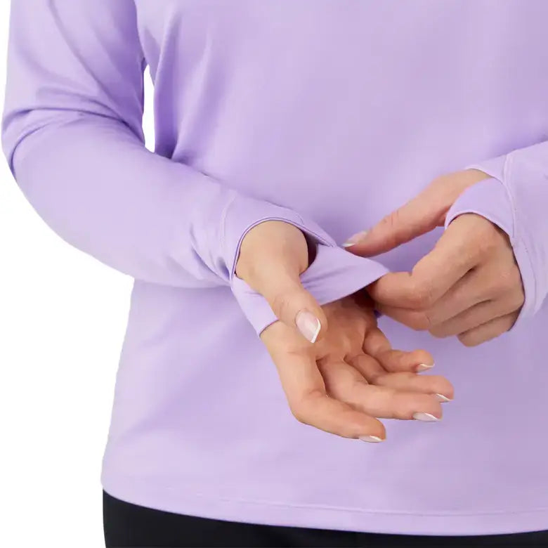 Close-up of a woman demonstrating the thumbhole feature in a Sea-Doo UV protection long sleeve shirt.