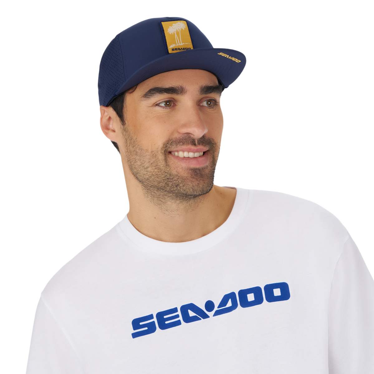 Unisex Sea-Doo Laser Cut Mesh Cap with palm tree design and Sea-Doo logo, worn by a man in a white shirt.