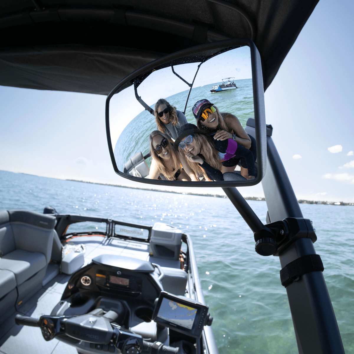 Sea-Doo Switch pontoon rearview mirror reflecting passengers riding on the water