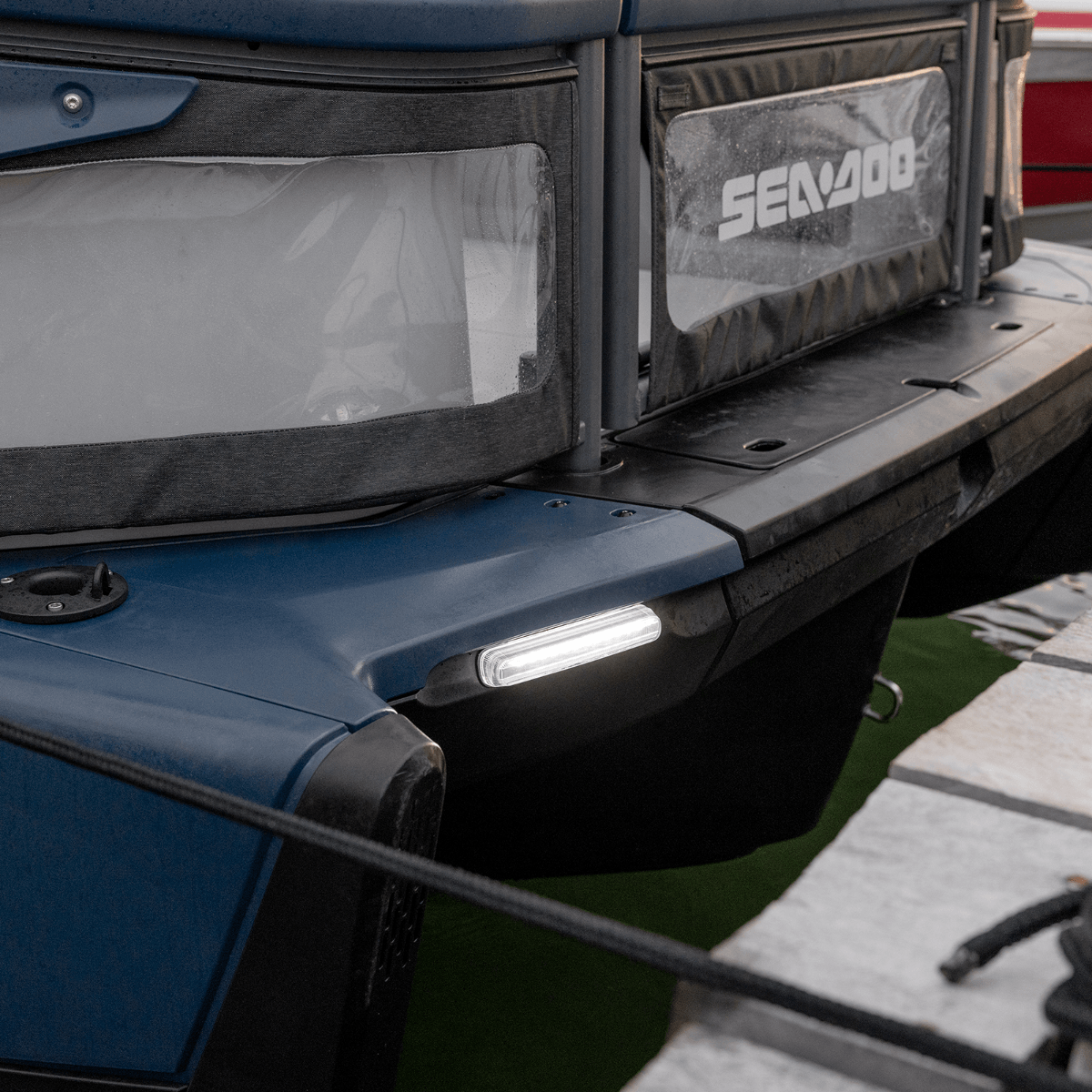 Sea-Doo Switch pontoon front docking light close-up on blue hull corner