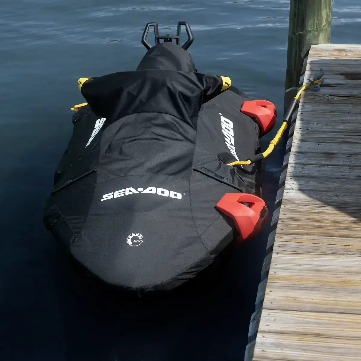 Sea-Doo Spark watercraft equipped with LinQ Lite fenders at a dock, showcasing durable black fabric and bright red attachments.