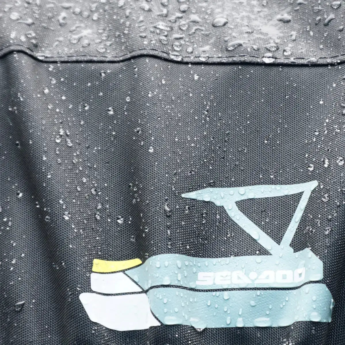 Sea-Doo Switch Sport 18 ft pontoon cover close-up showing water beading and logo, waterproof fabric texture
