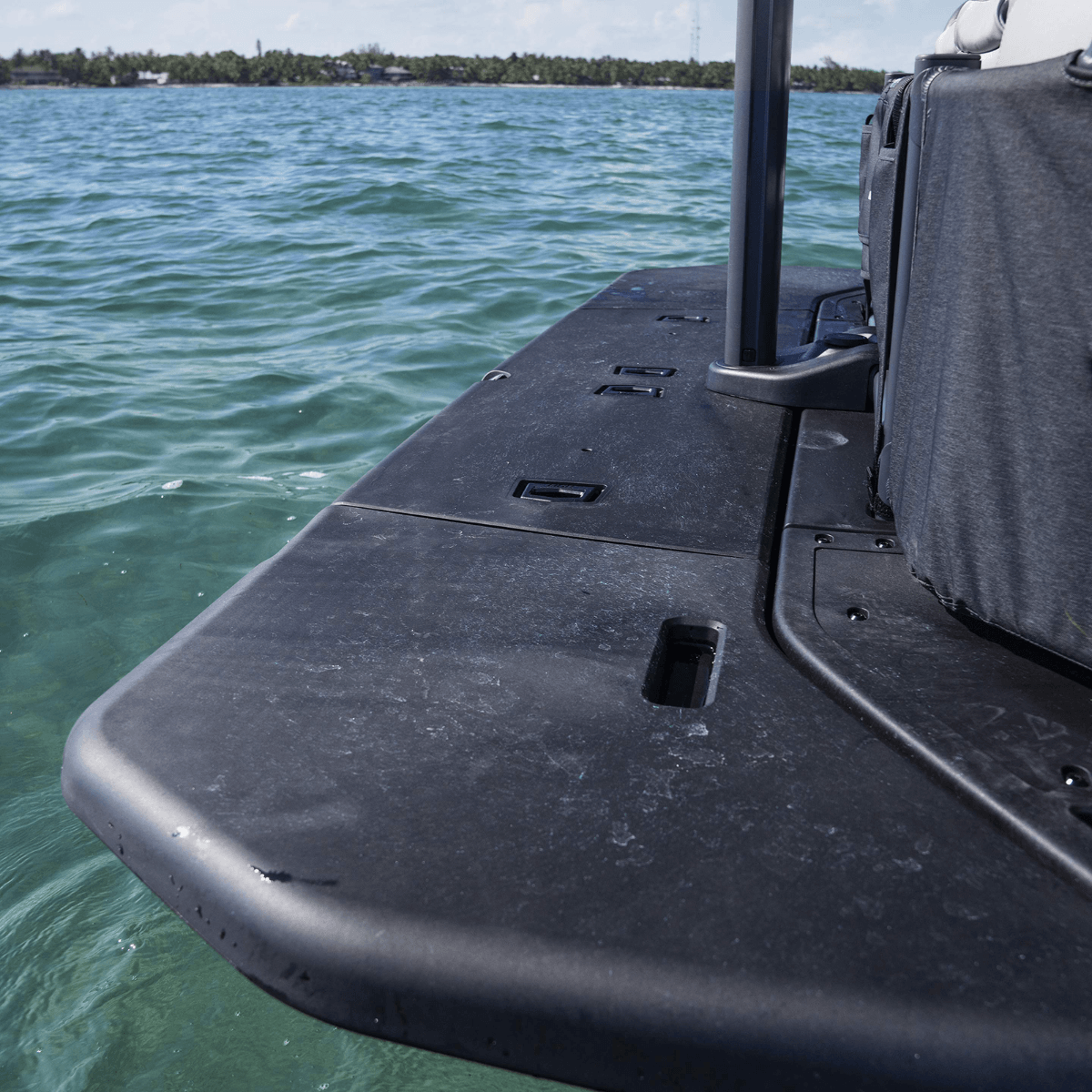 Sea-Doo Switch pontoon rear swim platform close-up black nonskid deck on water
