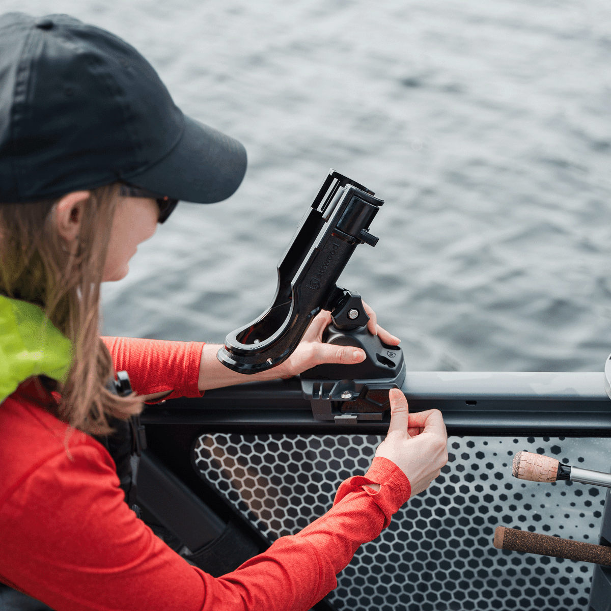 Angler installing Sea-Doo Rail Rod Holder with LinQ Lite mount on Switch pontoon rail