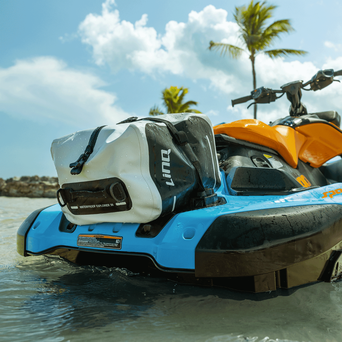 Sea-Doo LinQ Waterproof Explorer 30 dry bag mounted on blue Sea-Doo watercraft, beach setting