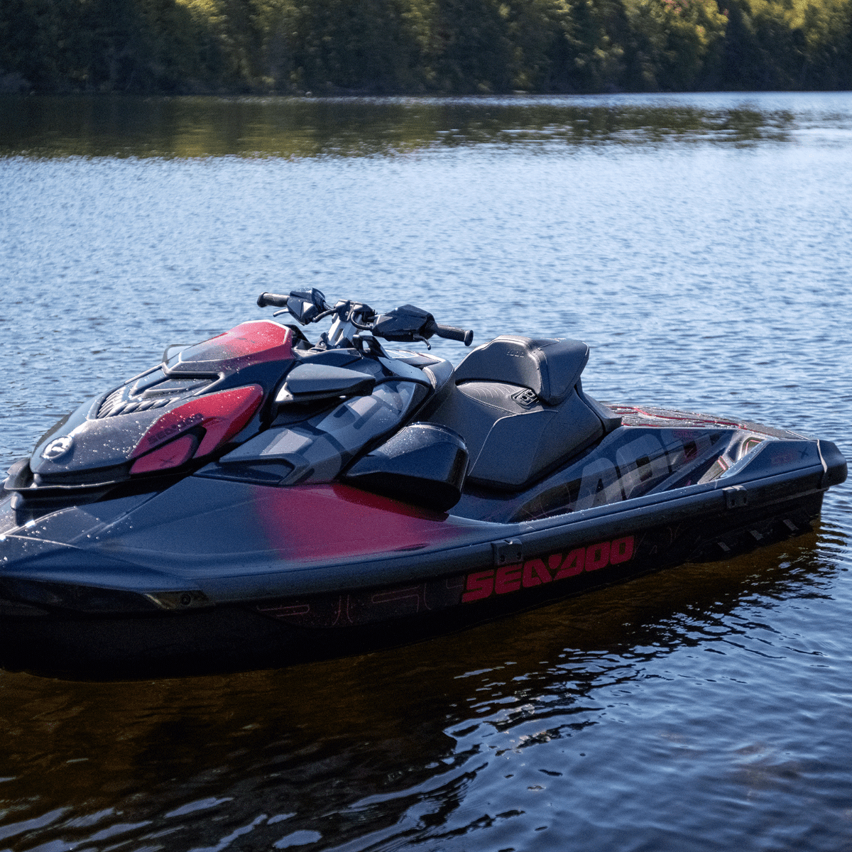 Sea-Doo RXP-X personal watercraft floating on lake showing black and red Ergolock R racing seat