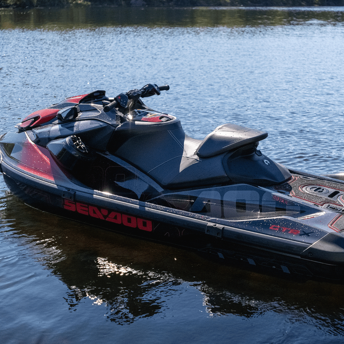 Black Sea-Doo GTR-X personal watercraft on lake showing Ergolock R racing seat and hull design