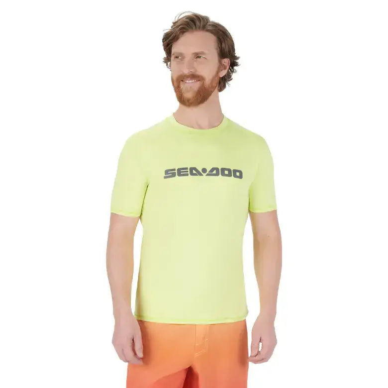 Man wearing a bright yellow t-shirt with 'SEADOO' logo on a white background