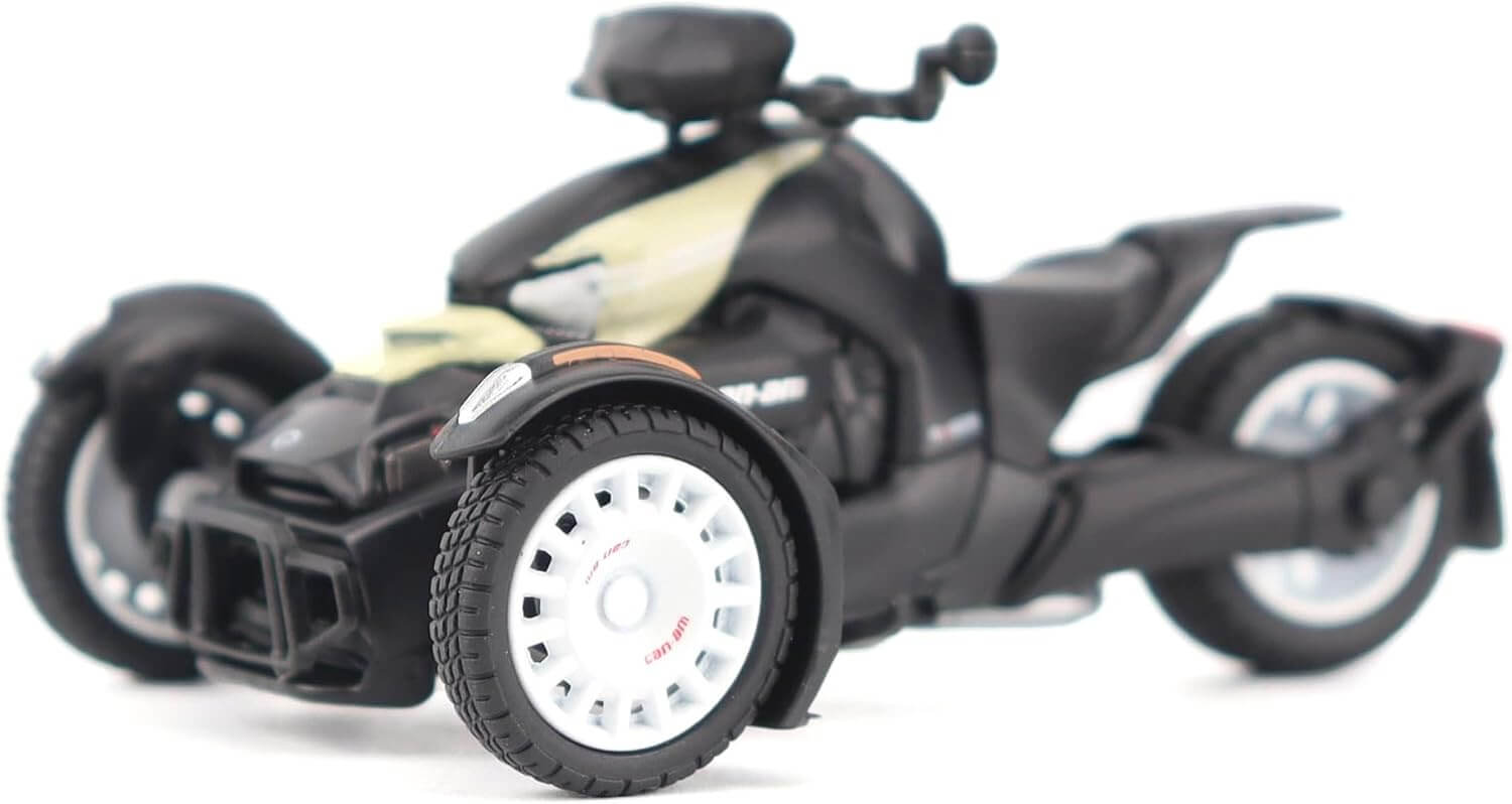 Black and gold toy motorcycle with three wheels on a white background