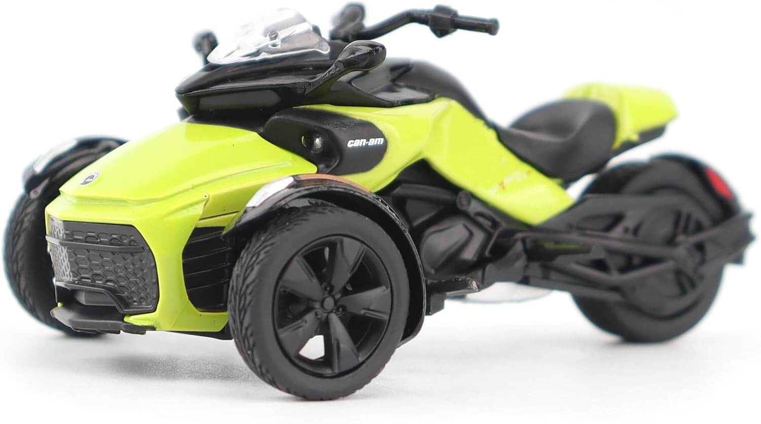 Model of a three-wheeled vehicle with a bright yellow body and black accents on a white background