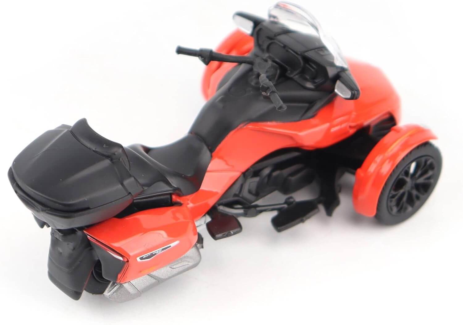 Red and black three-wheeled vehicle model on a white background