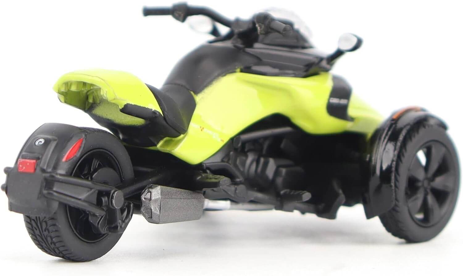 Model of a three-wheeled vehicle with a bright yellow body and black wheels on a white background