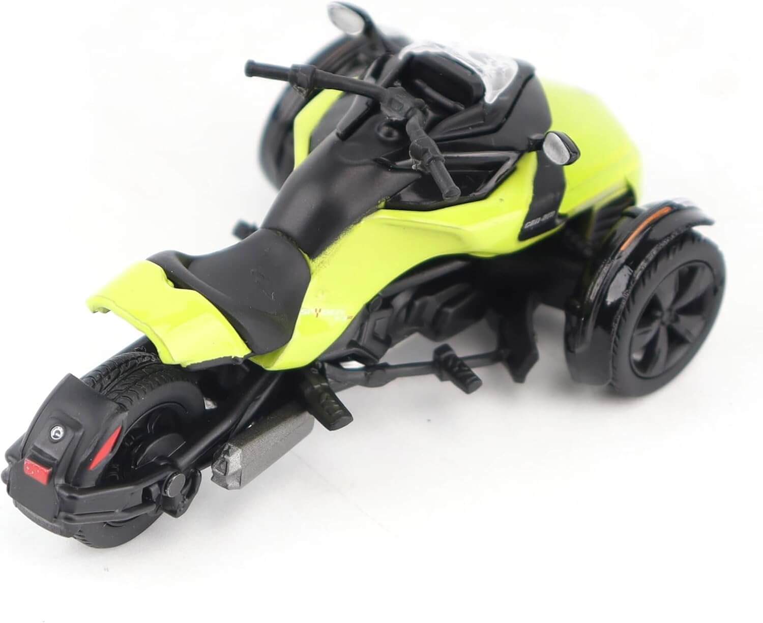 Yellow and black toy three wheel motorcycle on a white background