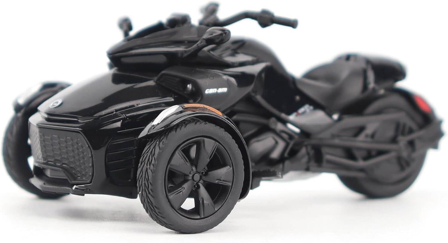 Black three-wheeled vehicle on a white background