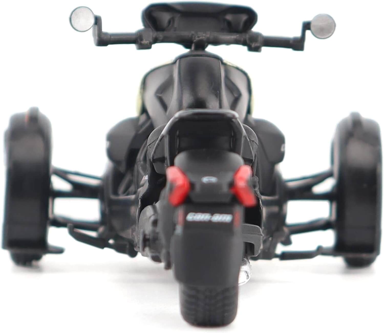 Black three-wheeled model vehicle on a white background