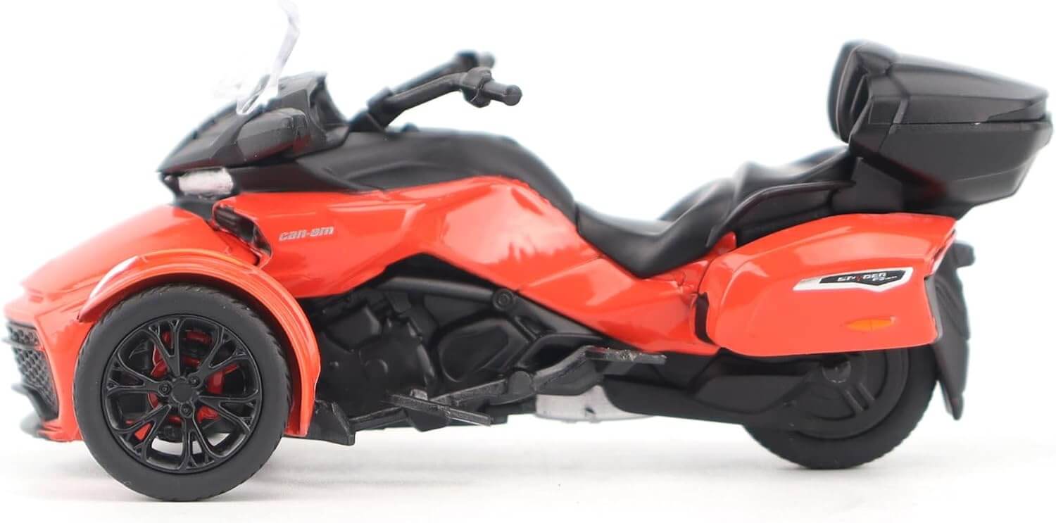 Red and black three-wheeled motorcycle toy on a white background