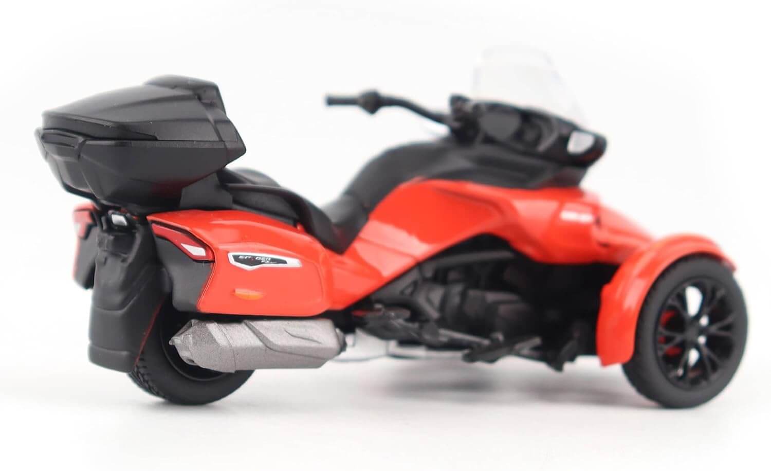 Red and black three-wheeled motorcycle model on a white background