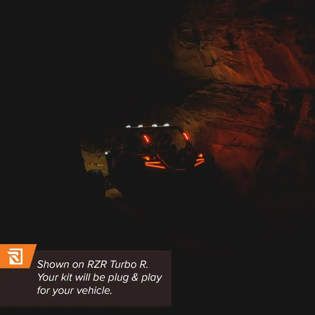 Off-road vehicle navigating a rocky terrain at night with text about RZR Turbo R compatibility.