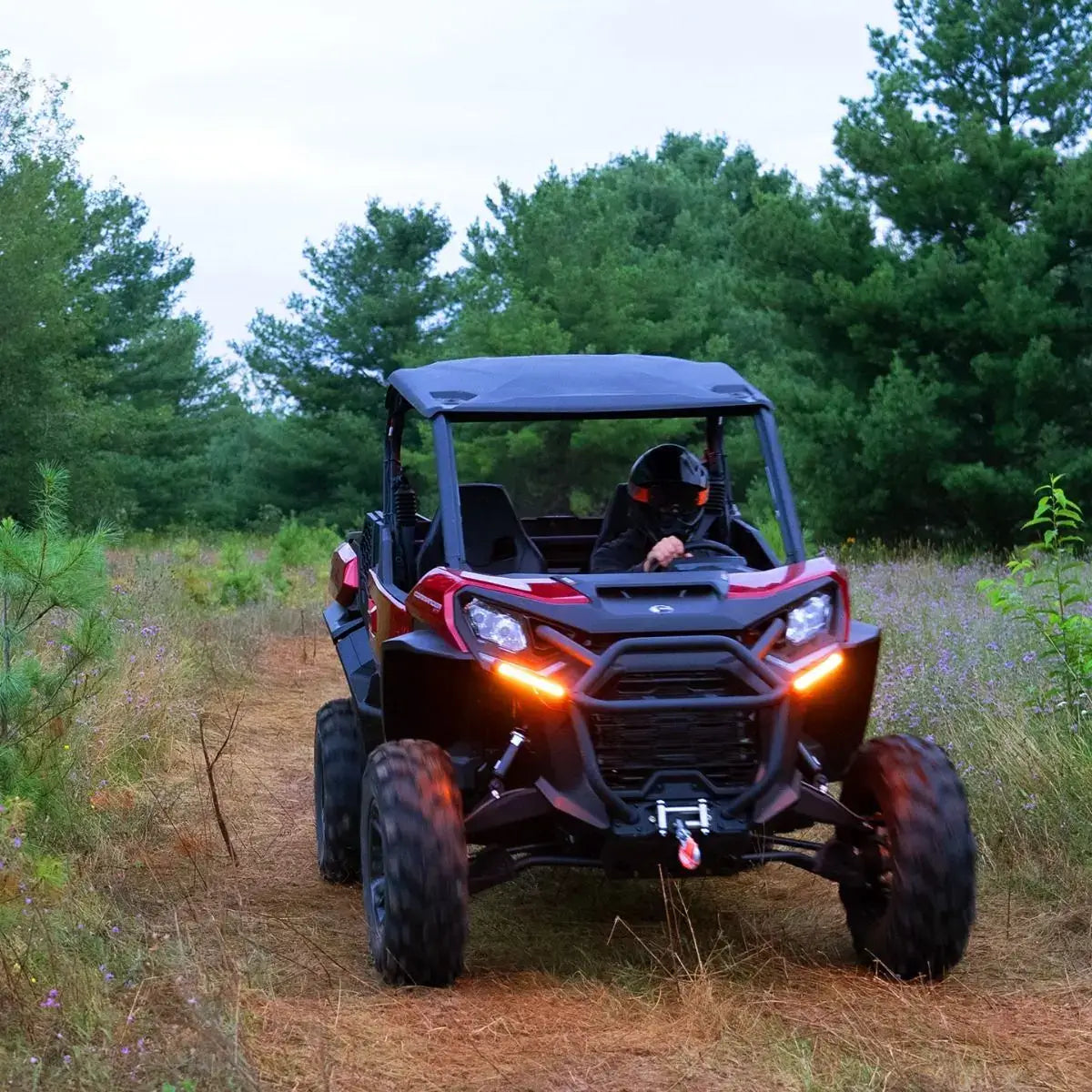 Off-road vehicle driving through a forested area