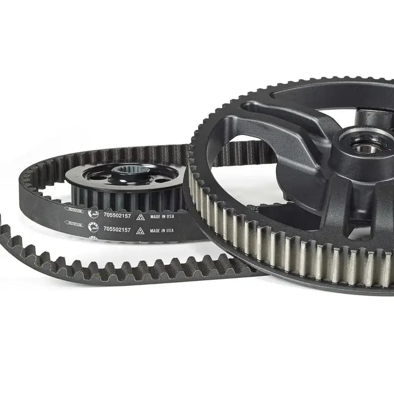 Close-up of mechanical gears and timing belt on a white background