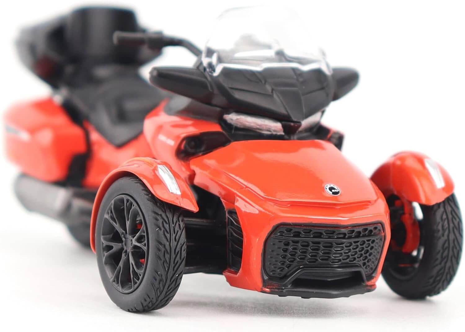 Red three-wheeled vehicle model on a white background