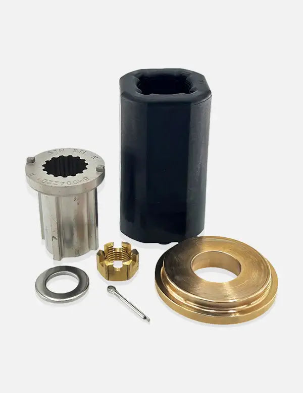 Set of mechanical components including a black cylindrical part, silver metallic component, brass ring, and washer on a white background.