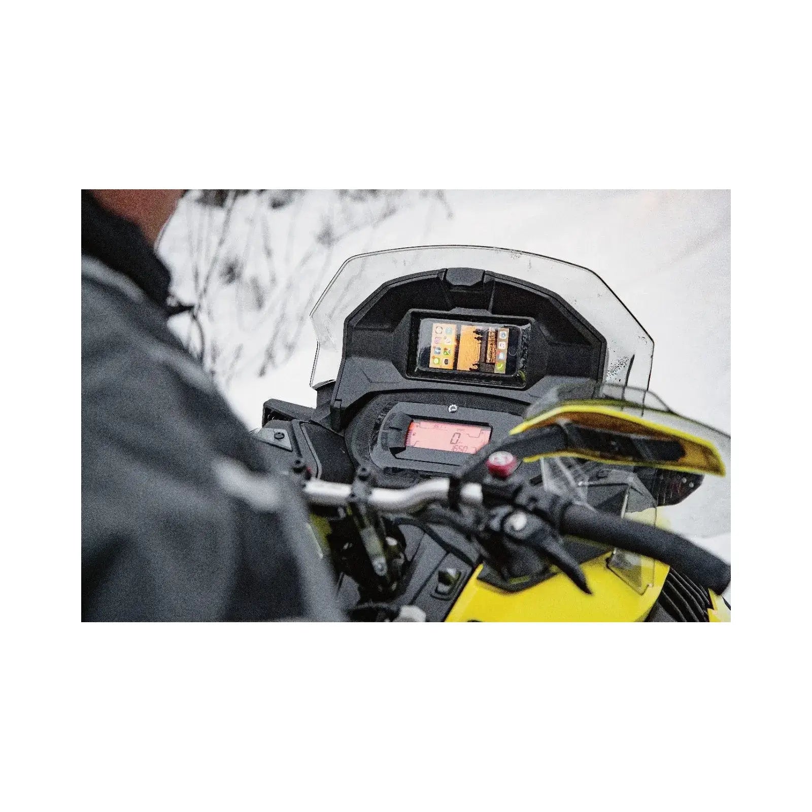 Person using glovebox extension with cellphone holder in winter environment