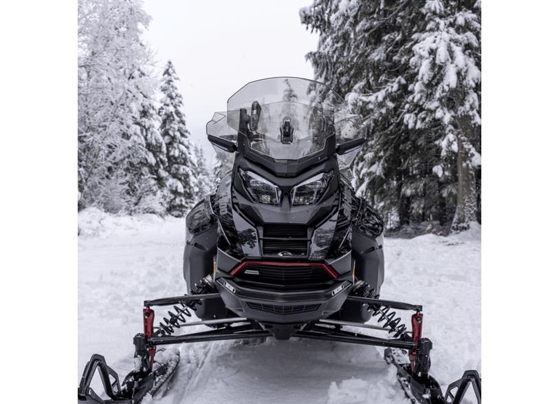 Ski-Doo REV Gen5 snowmobile with smoke adjustable medium-high windshield, front view on snowy trail
