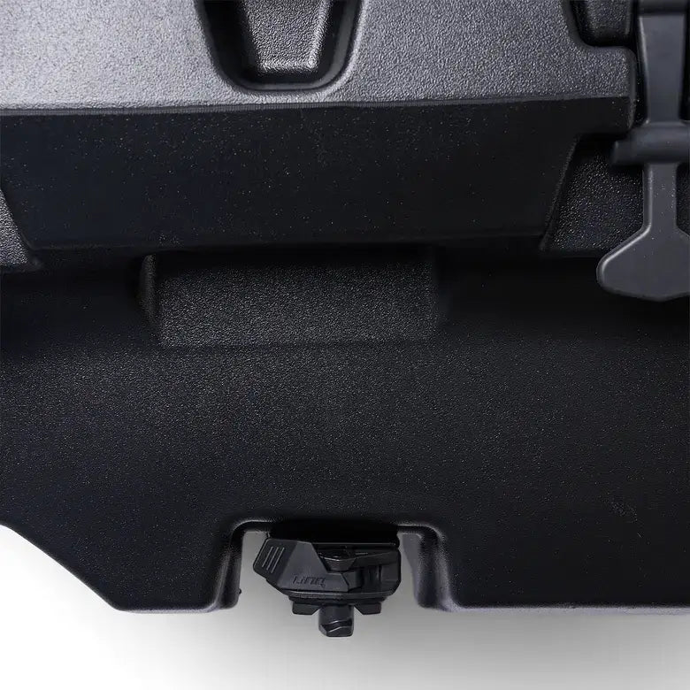 Close-up of a black suitcase handle and base on a white background