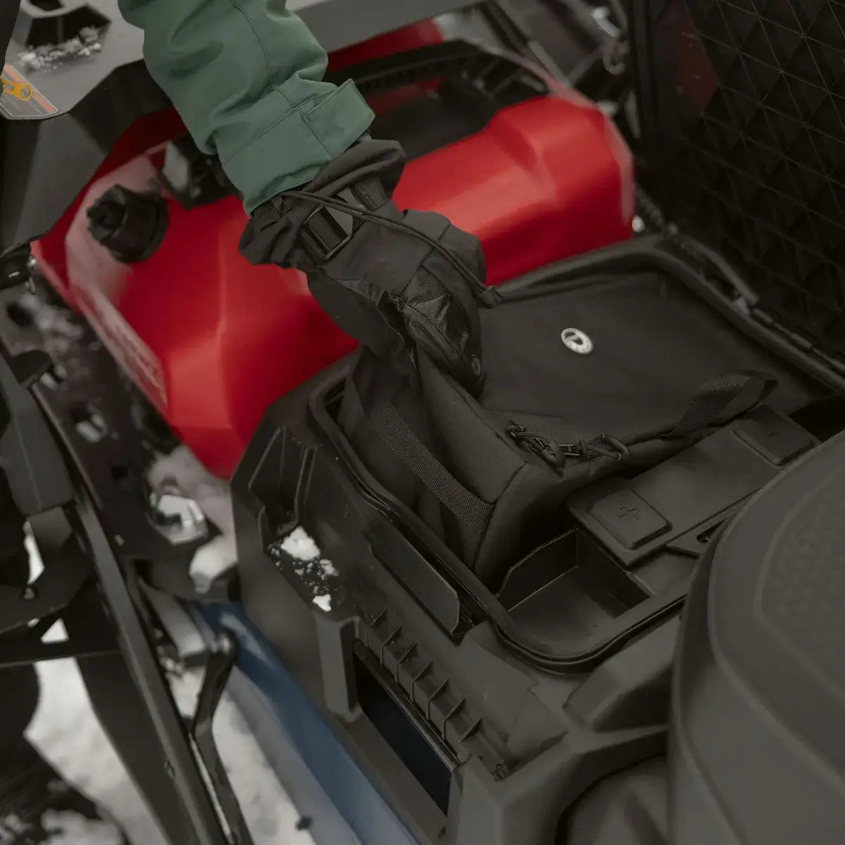 Ski-Doo underseat storage bag being stowed