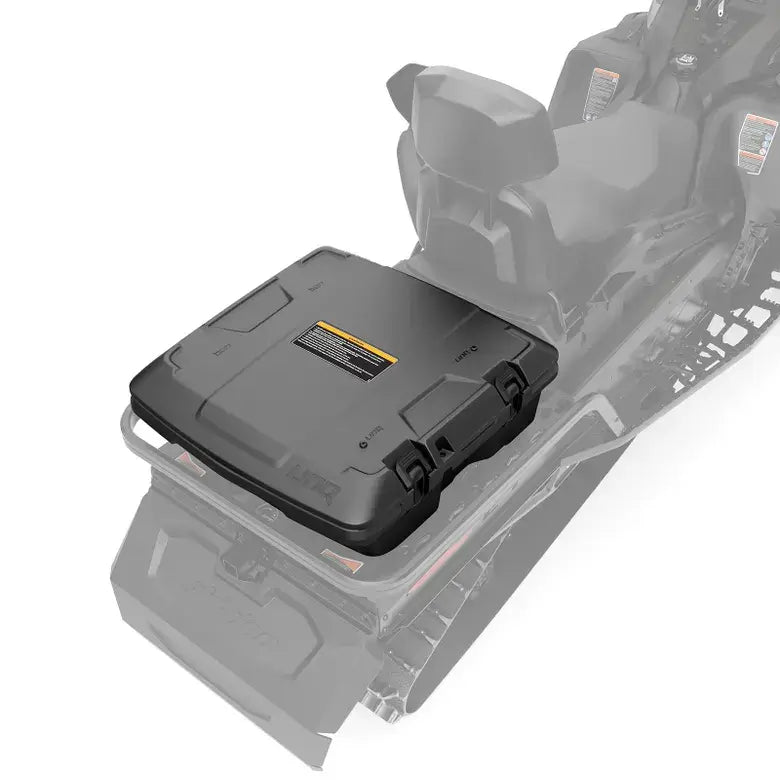 Black storage box attached to snowmobile