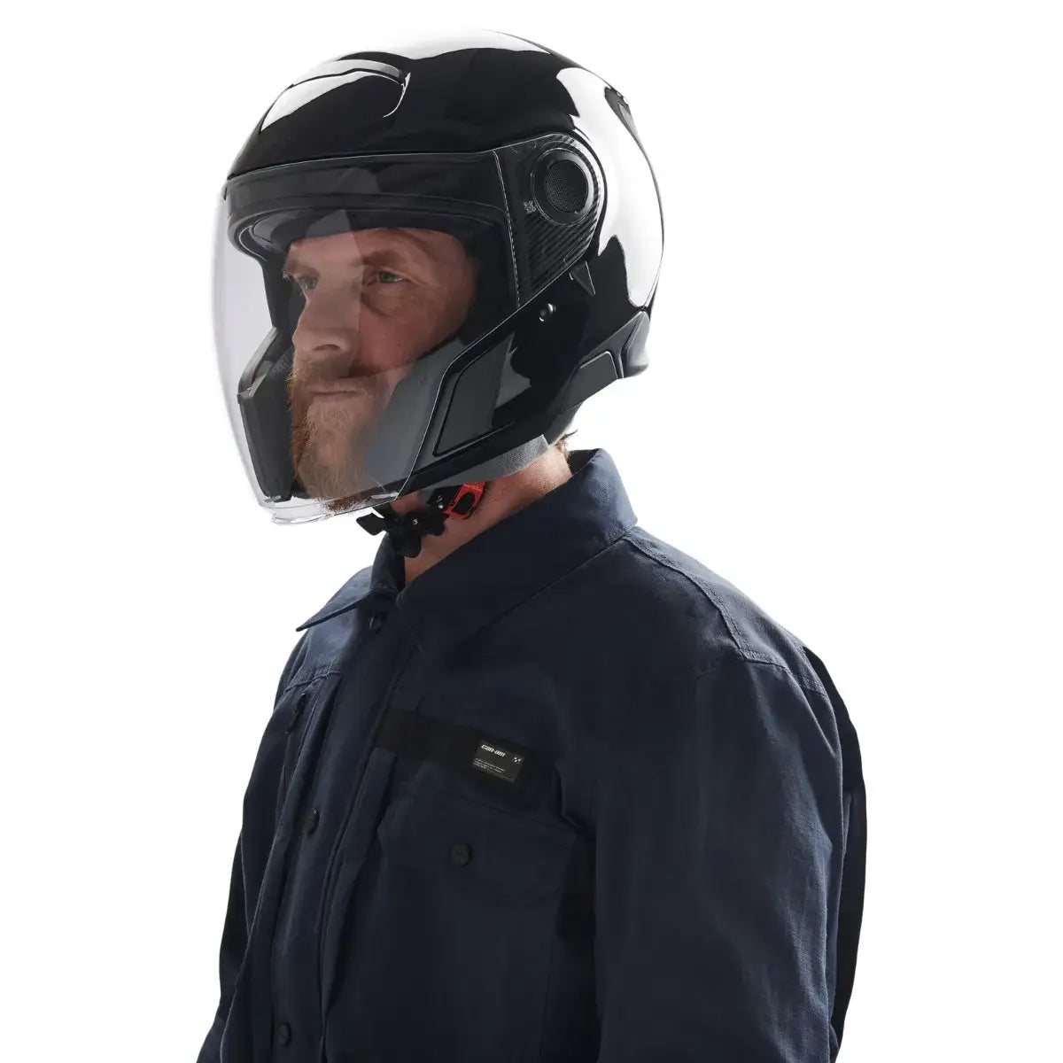 Man wearing a black motorcycle helmet with a clear visor on a white background