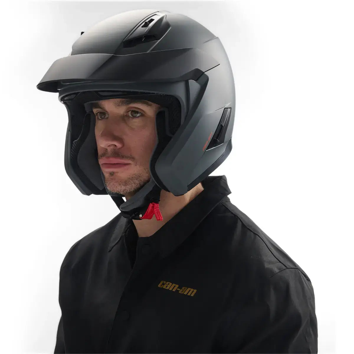 Person wearing a black helmet and black jacket with 'can-am' branding on a white background