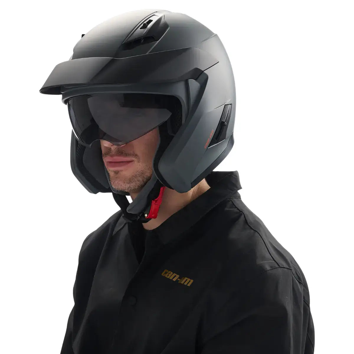 Person wearing a black motorcycle helmet with visor on a white background