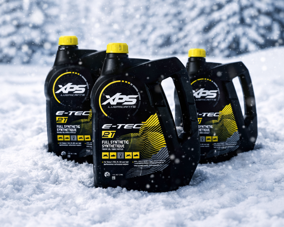 Three bottles of XPS E-TEC synthetic motor oil in the snow with a snowy background.