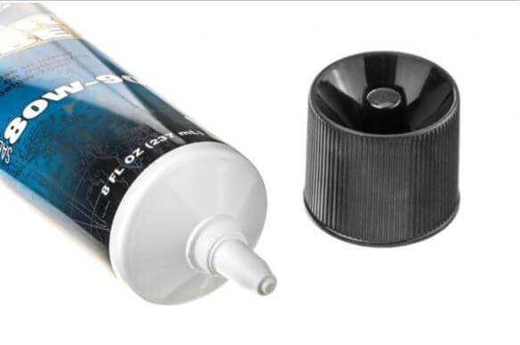 Tube of Quicksilver gear lube with cap off on white background