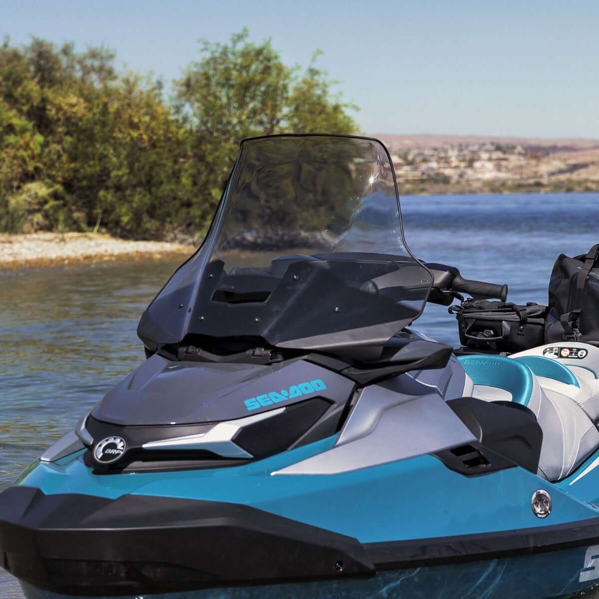 Sea-Doo touring windshield installed on teal Sea-Doo personal watercraft on lake